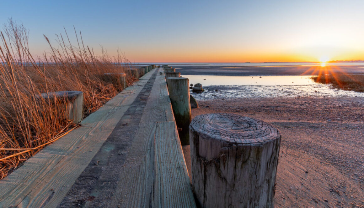 Breakwater at Harvey's Beach in Connecticut at sunset on a cloudless day
