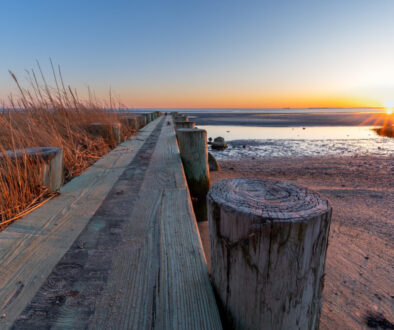 Breakwater at Harvey's Beach in Connecticut at sunset on a cloudless day