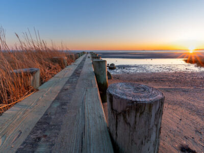 Breakwater at Harvey's Beach in Connecticut at sunset on a cloudless day