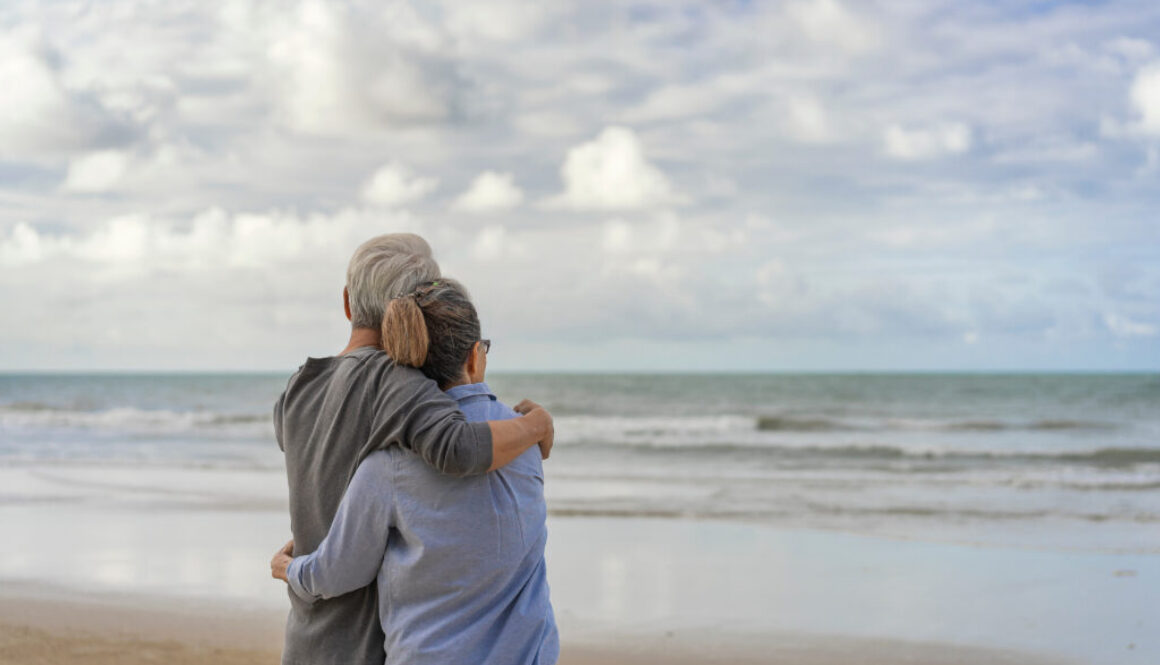 The elderly couples embraced at the seaside.The elderly couples embraced at the seaside.An old couple hugged by the sea.Mature couples relax at the seaside on holiday.