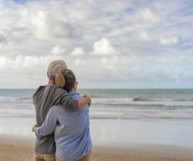 The elderly couples embraced at the seaside.The elderly couples embraced at the seaside.An old couple hugged by the sea.Mature couples relax at the seaside on holiday.