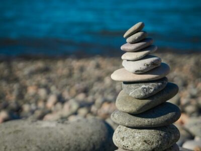 rocks balancing on top of one another, representing work-life balance tension and time management for business owners