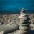 rocks balancing on top of one another, representing work-life balance tension and time management for business owners