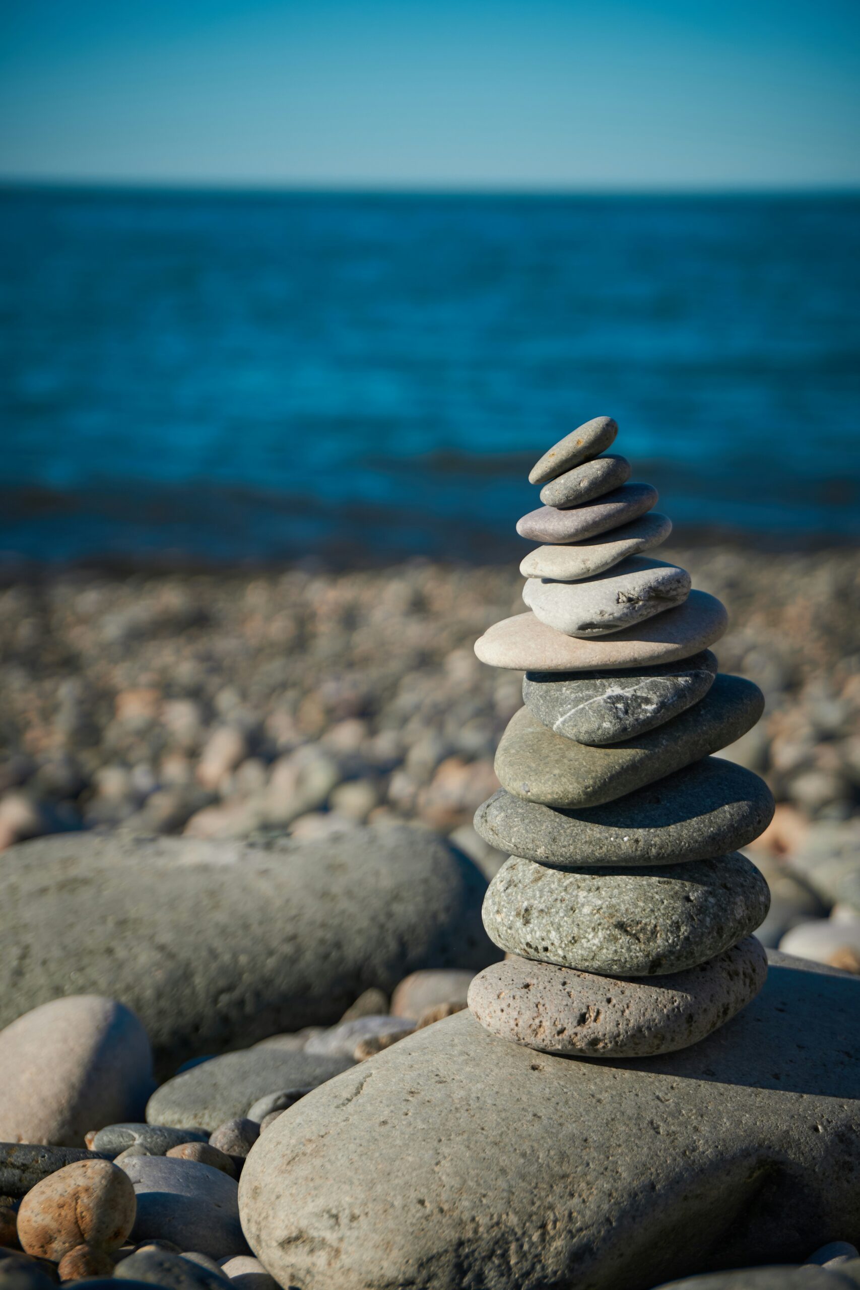 rocks balancing on top of one another, representing work-life balance tension and time management for business owners